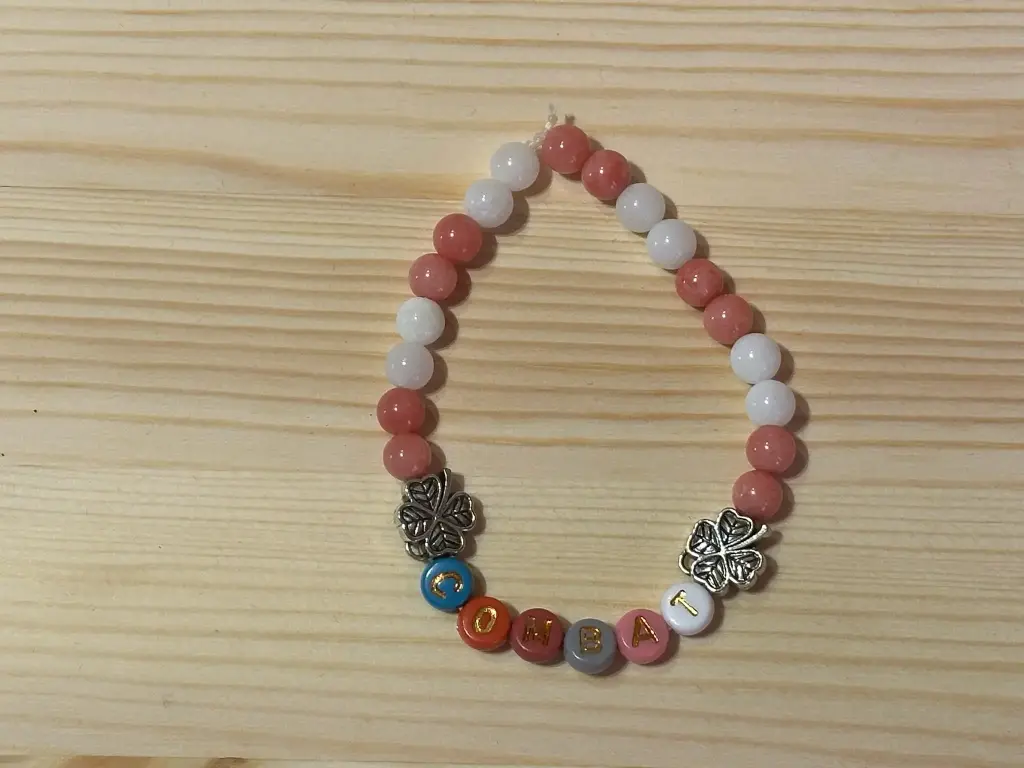 Bracelet en perles blanches, roses, trèfles avec inscription "combat" taille 16cm